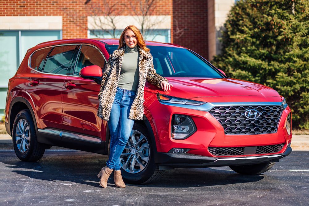 WOMAN NEXT TO CAR